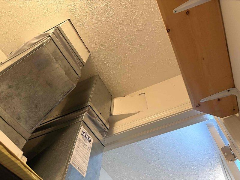 Responded to customer complaint of furnace not producing hot air during previous winter heating season. Performed comprehensive system evaluation of existing heating equipment with unknown age and service history. Assessed air handler and ductwork configuration, documented equipment condition through photographs showing aged metal ductwork with visible dust accumulation and discoloration. Based on system age, condition, and heating failure, provided detailed estimate for complete HVAC system replacement to restore whole-house heating functionality.