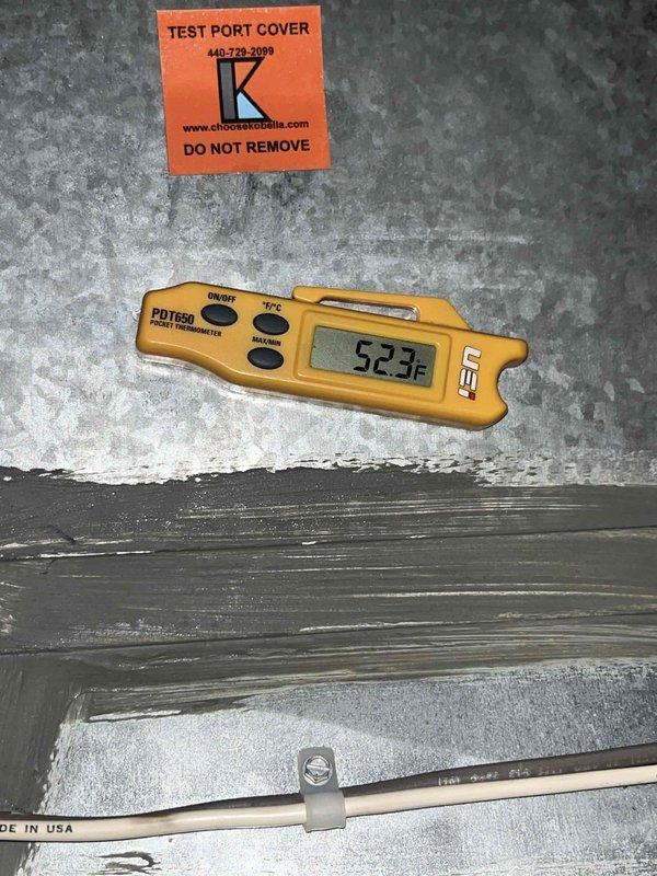 Completed cooling maintenance club visit on air handler unit. Upon arrival, discovered fuse panel door had been left open with fuses dislodged from their positions. Secured all fuses back into proper locations and closed fuse panel door to restore safe operating condition. Inspected condensate drain system and documented debris accumulation in drain trap assembly. Performed temperature verification at test port, recording supply air temperature of 52.3°F, confirming proper cooling operation. System restored to normal operating parameters with all safety components properly secured.