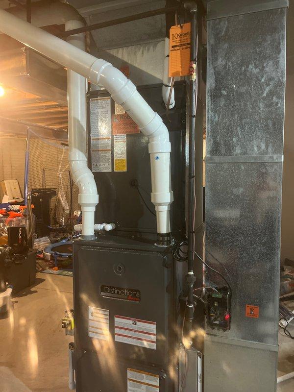 Completed installation of new air conditioning system and evaporator coil at residential property. Installed outdoor condensing unit with proper electrical disconnect and fusing, ensuring all connections meet code requirements and manufacturer specifications. Mounted and leveled exterior disconnect box on building exterior with appropriate copper fusing components. Inside the mechanical room, installed new evaporator coil integrated with existing furnace system, completing all refrigerant line connections and condensate drainage. Configured PVC venting system and verified proper clearances for all components. System was pressure tested, evacuated, and charged to manufacturer specifications. Performed operational testing to confirm proper system function, airflow, and temperature differential across the coil.