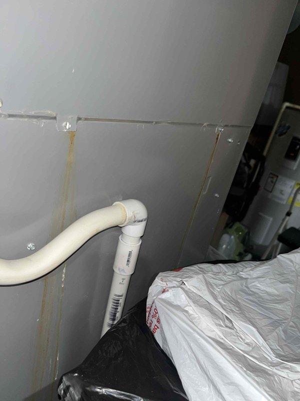 Completed heating maintenance inspection and diagnostics. Observed water staining on wall near PVC condensate drain line indicating potential drainage issues or past overflow events. Verified system temperatures using calibrated digital thermometer, recording 84.3°F reading at equipment location. Documented existing conditions with photographic evidence for maintenance records.