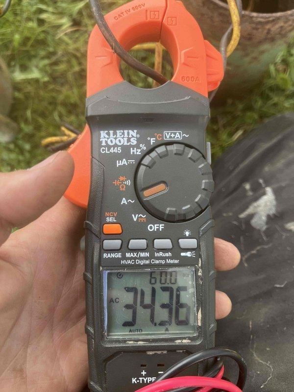 Responded to low water pressure emergency call where customer experienced sudden pressure loss during shower use accompanied by unusual pump noise. Upon arrival, performed diagnostic testing of well pump system using digital clamp meter, which revealed abnormal electrical readings of 343 volts, indicating potential power supply issues affecting pump performance. Inspected water supply infrastructure in crawl space and identified severely corroded copper piping with heavy turquoise-green patina buildup that could contribute to flow restriction. Documented existing conditions of plumbing system including deteriorated pipe sections and mounting hardware for recommended repairs to restore proper water pressure and prevent future system failure.