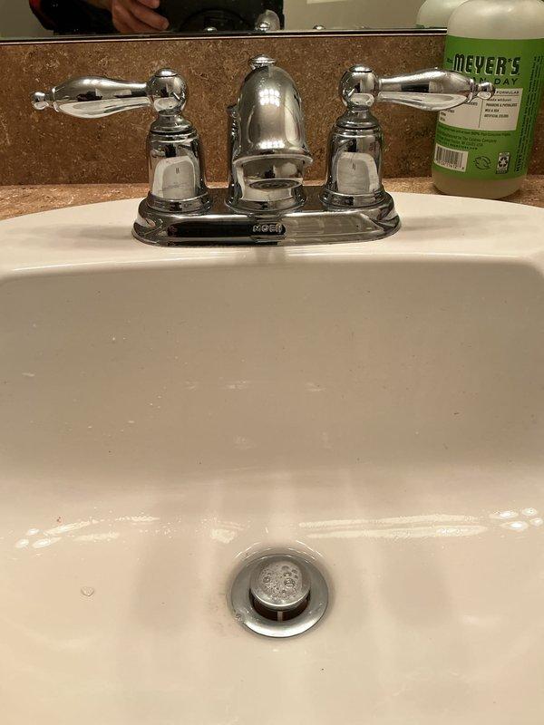 Completed club membership plumbing maintenance inspection of residential property. Performed visual assessment of bathroom sink faucet and under-sink plumbing connections, documenting chrome two-handle faucet fixture and LASCO PVC drain assembly with P-trap and shut-off valves in proper working condition. Discussed buy-one-get-one spigot promotion with customer and identified need to assess tankless water heater system for future service consideration while processing club membership renewal.