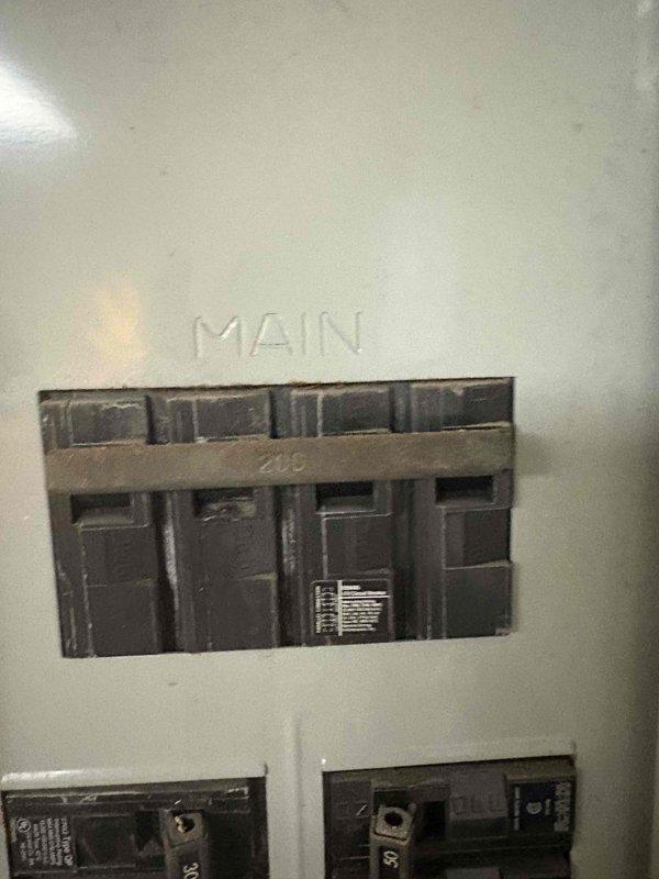 Performed estimate for ductless mini-split installation in three-season room. Evaluated existing 200-amp electrical panel for capacity and confirmed adequate breaker space available for new mini-split system. Assessed installation location and documented room layout with wood-paneled construction and existing ceiling-mounted fan to determine optimal placement for indoor air handler unit.