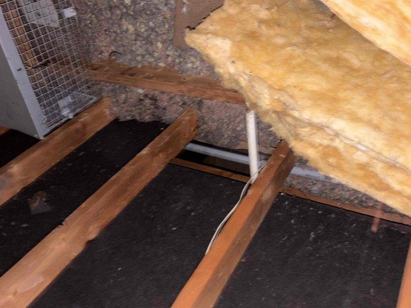 Responded to service call for water dripping from AC unit in garage. Conducted thorough assessment of attic space and HVAC system components to identify source of moisture issue. Documented existing system configuration, including measurements of attic access opening and condition of ductwork, insulation, and drainage lines. Photographed affected areas showing PVC condensate drain line routing through attic space and potential drainage concerns. Provided comprehensive replacement options and recommendations based on findings from visual inspection of equipment accessibility and installation requirements.