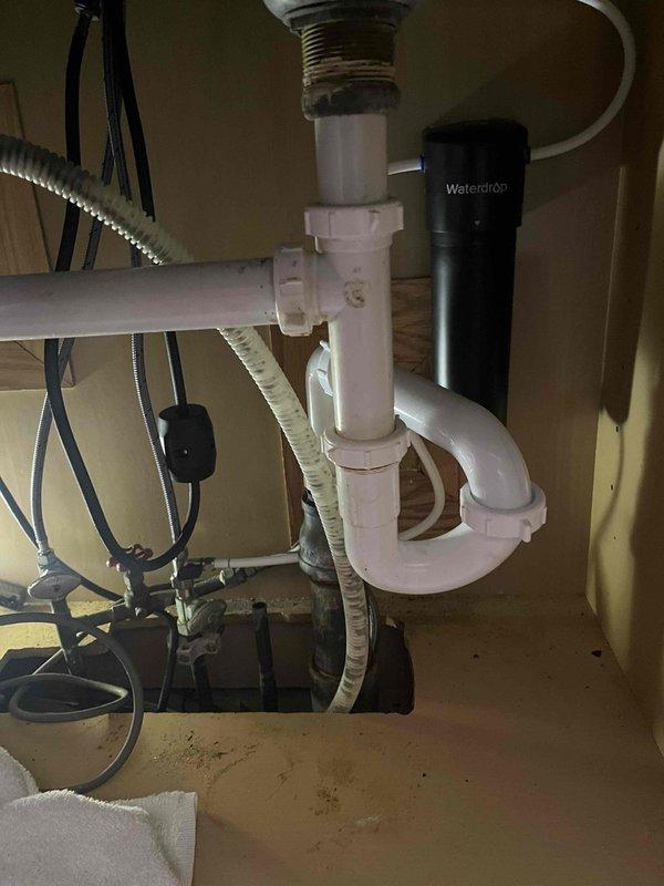 Completed kitchen faucet replacement using customer-supplied fixture. Disconnected existing faucet assembly and removed old supply lines. Installed new faucet unit, connected braided stainless steel supply lines to hot and cold water shut-off valves, and verified proper alignment with sink mounting holes. Tested installation for leaks and confirmed full water flow and proper drainage through existing P-trap assembly.