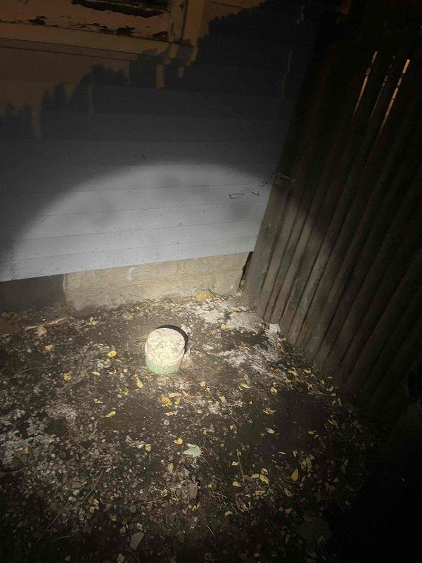Responded to Unit 4 for sewer line backup with sewage discharge from outdoor cleanout. Upon arrival, found the cleanout cap had detached, allowing raw sewage to overflow onto the ground surface. Assessed the main sewer line blockage causing the backup condition. Documented the extensive sewage contamination in the affected area showing deteriorated surfaces and standing wastewater. Addressed the immediate sewer emergency and restored proper drainage function to prevent further sewage discharge from the cleanout access point.
