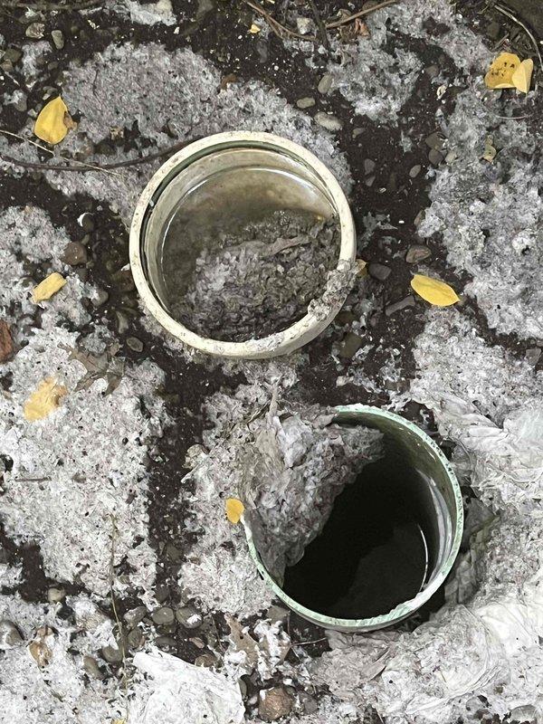 Responded to Unit 4 for sewer line backup with sewage discharge from outdoor cleanout. Upon arrival, found the cleanout cap had detached, allowing raw sewage to overflow onto the ground surface. Assessed the main sewer line blockage causing the backup condition. Documented the extensive sewage contamination in the affected area showing deteriorated surfaces and standing wastewater. Addressed the immediate sewer emergency and restored proper drainage function to prevent further sewage discharge from the cleanout access point.