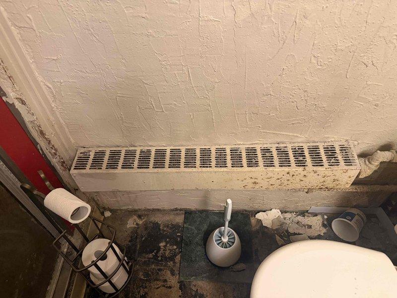 Responded to service call for leaking radiator pipe in bathroom. Upon inspection, identified active leak at pipe connection to baseboard heating unit. Repaired leaking connection, tested system for proper operation, and confirmed no additional leaks present.