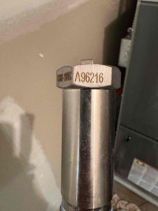Performed return service on 75-gallon water heater system with maintenance kit installation. Inspected and documented anode rod condition (visible identification tag A96216) and verified proper mounting of circulation pump assembly on block wall. Thermal imaging revealed normal operational heat distribution on motor housing with characteristic gradient pattern indicating proper function. Completed maintenance protocol including component inspection and system verification.