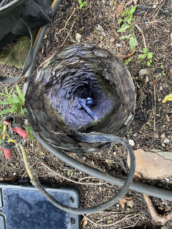Responded to emergency no-water call and located well system with severely deteriorated well cap and compromised electrical connections. Inspected well shaft showing significant age-related deterioration with mineral deposits, algae growth, and structural concerns. Identified exposed and improperly protected wire splices with wire nuts inside deteriorated well cap assembly, creating potential safety hazard and contributing to system failure. Documented conditions of well infrastructure including damaged cap, exposed wiring connections, and overall system deterioration requiring immediate attention to restore water service and ensure safe operation.