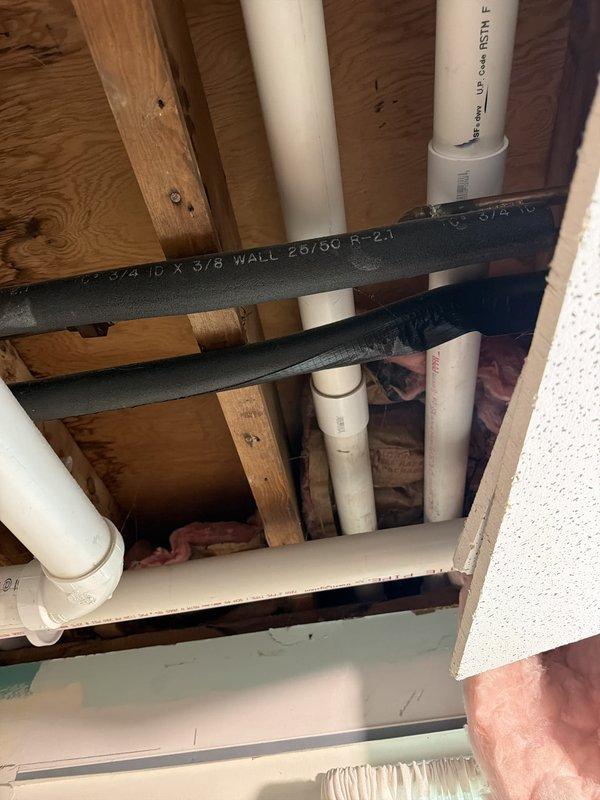 Completed full HVAC system installation following laundry room remodel. Installed new ductwork, refrigerant lines, and condensate drainage through wall cavity and floor joists, coordinating with existing plumbing infrastructure. Mounted exterior condensing unit on brick wall with proper mounting bracket and line set penetration through soffit, ensuring proper clearances and secure attachment. Retrieved temporary portable and window AC units from property upon completion of permanent system installation.