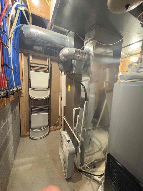 Conducted comprehensive assessment of existing 16-17 year old heating system and multiple HVAC units in residential basement installation. Evaluated current equipment configuration including furnace/air handler with extensive ductwork system, existing water heater, and multiple zone requirements for replacement consideration. Provided estimates for complete system replacement including multi-zone HVAC configuration, tankless water heater conversion, and water treatment system integration to meet homeowner's modernization objectives.