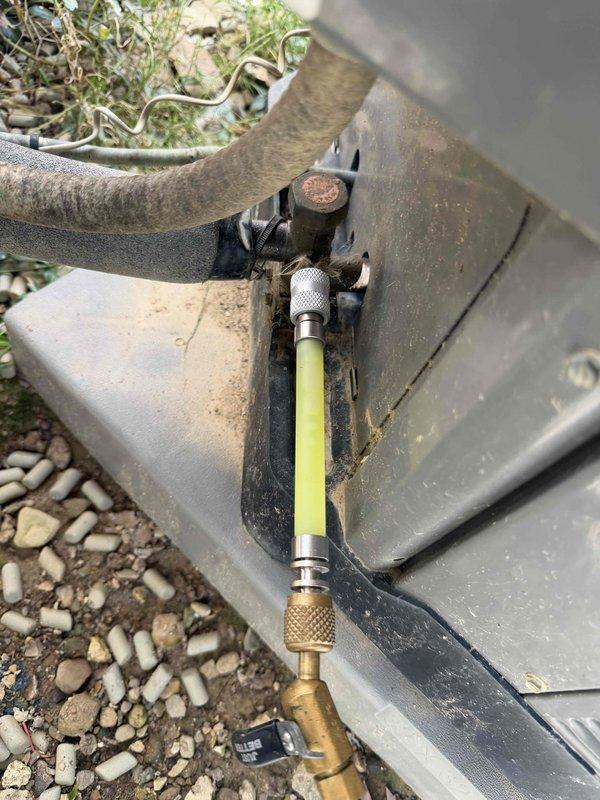 Returned to property to perform leak search on outdoor HVAC condensing unit as previously sold. Connected refrigerant gauges and service hoses to unit's service ports to diagnose reported system issue. Upon inspection, noted corroded service valve and weathered refrigerant line connections showing signs of potential leak points. Performed thorough leak detection procedures on all refrigerant line connections, service ports, and accessible joints. Additionally addressed customer inquiry regarding dryer vent cover installation, advising that such modifications may violate local building codes and would require further evaluation for compliance.