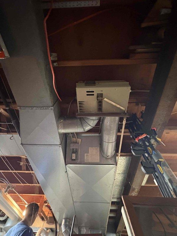 Responded to service call for non-operational air conditioning system affecting cooling capability. Upon arrival, evaluated existing ten-year-old AC system and associated equipment including Carrier Infinity Touch thermostat control and basement-installed ductwork configuration. Documented current system conditions through photographic assessment of HVAC equipment installation, including metal ductwork, control housing, and thermostat interface displaying active cooling mode at 69° room temperature. Provided comprehensive estimate for complete system replacement based on equipment age and operational status.