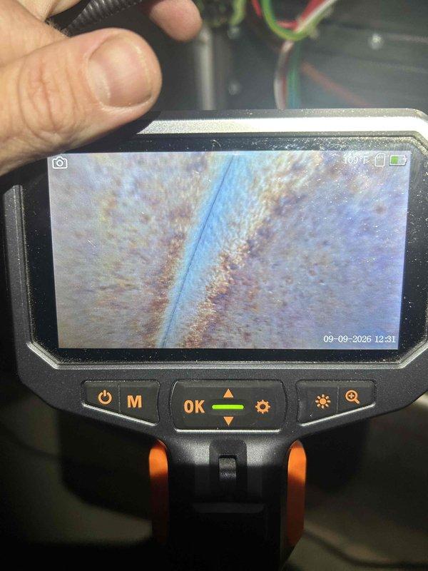 Completed final prepaid heating maintenance visit on air handler unit. Performed standard heating system inspection and testing. Addressed drain line issue on dehumidifier by correcting improper pitch that was preventing proper condensate drainage. Used inspection camera to examine internal components and identified corrosion on metal surfaces within the system, documenting conditions with detailed imagery for service records.