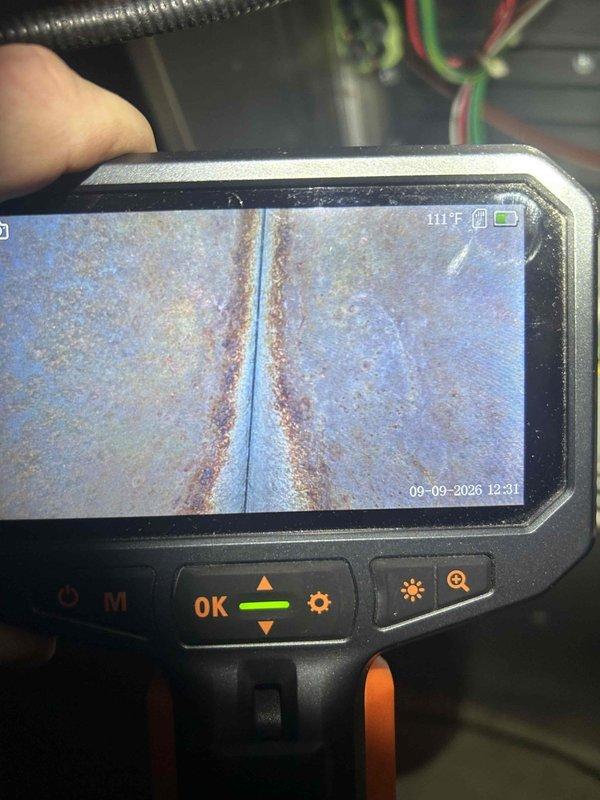 Completed final prepaid heating maintenance visit on air handler unit. Performed standard heating system inspection and testing. Addressed drain line issue on dehumidifier by correcting improper pitch that was preventing proper condensate drainage. Used inspection camera to examine internal components and identified corrosion on metal surfaces within the system, documenting conditions with detailed imagery for service records.