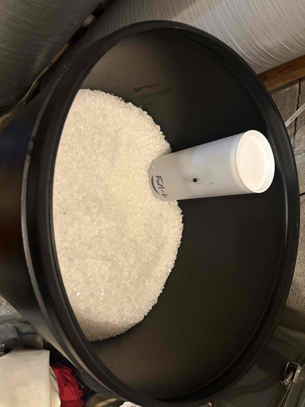 Responded to service call for water softener brine tank overfilling issue on equipment less than one year old. Diagnosed malfunction causing continuous water flow into brine tank, inspected salt levels and internal components, and performed necessary adjustments to restore proper operation. Verified system functionality and documented equipment condition with photos showing brine tank salt levels and ambient temperature readings.