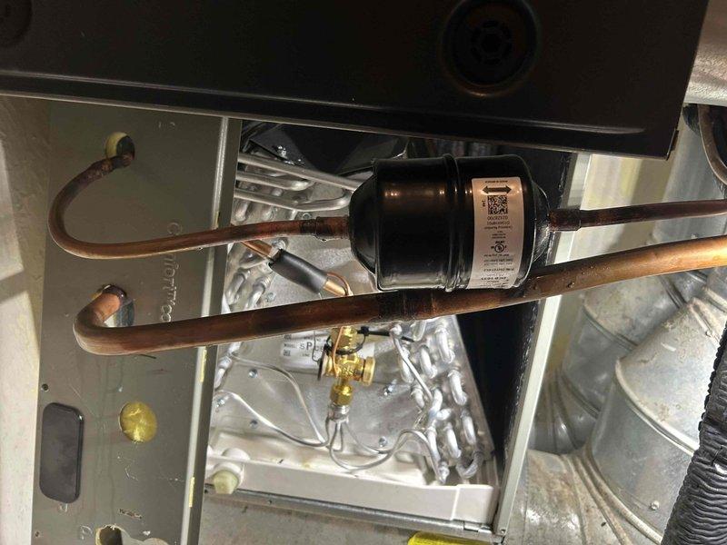 Performed return air zone inspection and system evaluation. Documented internal HVAC components including evaporator coil assembly, refrigerant lines, and metering device. Captured images of serpentine coil configuration with brass expansion valve and capillary tube sensing element for service records. All copper refrigerant lines and electrical connections verified to be properly secured within unit cabinet.