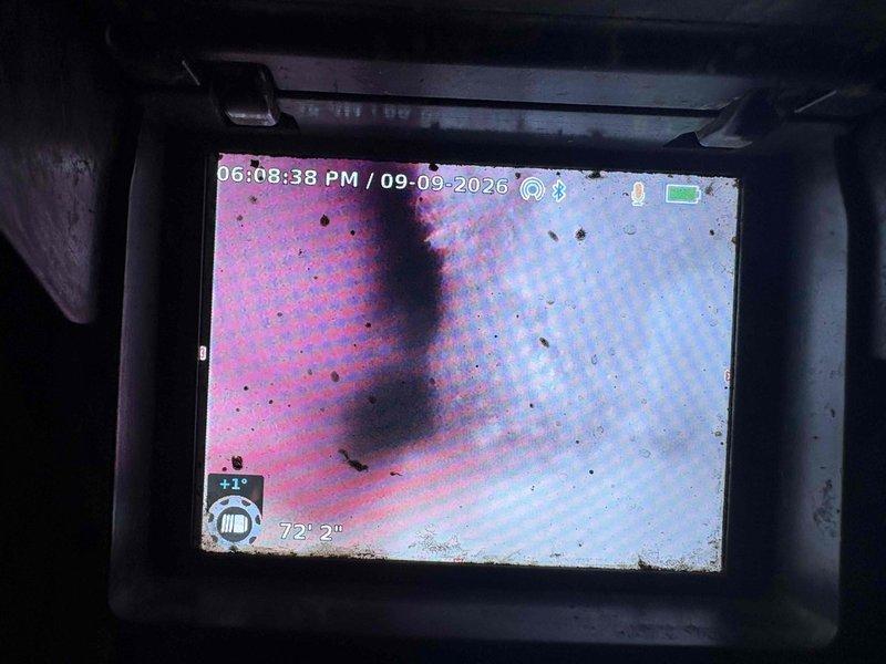 Responded to a bottom floor toilet overflowing when other toilets in the residence were flushed, indicating a main drain line obstruction. Performed video camera inspection of the drainage system to identify the blockage location and severity, revealing debris accumulation within the pipe. Successfully cleared the clog, restoring proper drainage function to all affected fixtures.