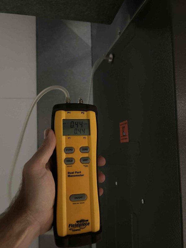 Completed routine cooling maintenance member visit on air handler system. Performed standard diagnostic measurements using digital manometer to verify proper airflow and static pressure readings across the system. All measurements were within acceptable operating parameters. Inspected condensate drain system and documented existing plumbing configuration including P-trap assembly and shut-off valve. System operating normally with no immediate service needs identified.