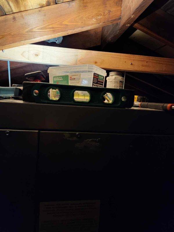 Responded to service call for vibrating air handler in attic space. Upon inspection, accessed unit through ceiling panel and performed diagnostic assessment of air handler operation and mounting. Measured access opening and verified proper clearances for equipment service. Inspected air handler installation, checking for loose mounting hardware, ductwork connections, and potential sources of vibration. Used level to verify unit positioning and identify any settling or misalignment issues that could cause operational noise. Documented equipment condition and access configuration for service records.