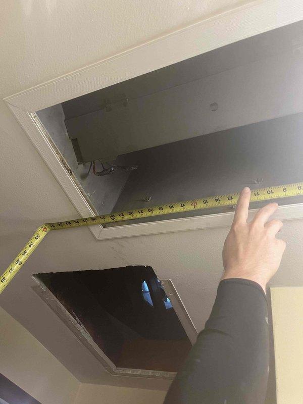 Responded to service call for vibrating air handler in attic space. Upon inspection, accessed unit through ceiling panel and performed diagnostic assessment of air handler operation and mounting. Measured access opening and verified proper clearances for equipment service. Inspected air handler installation, checking for loose mounting hardware, ductwork connections, and potential sources of vibration. Used level to verify unit positioning and identify any settling or misalignment issues that could cause operational noise. Documented equipment condition and access configuration for service records.