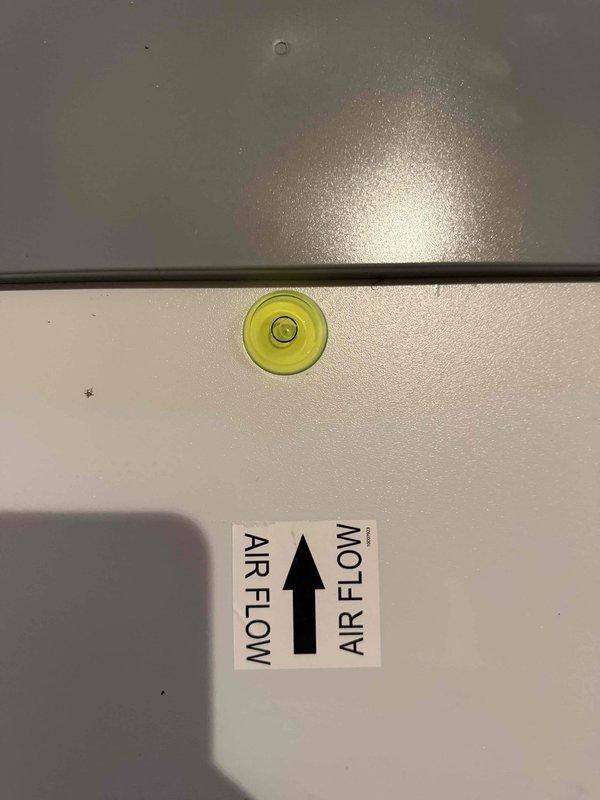 Completed installation of whole house dehumidification system with proper leveling and airflow orientation verified. Unit mounted and configured with digital controls set to 50% humidity level, all electrical connections secured, and system tested for proper operation.