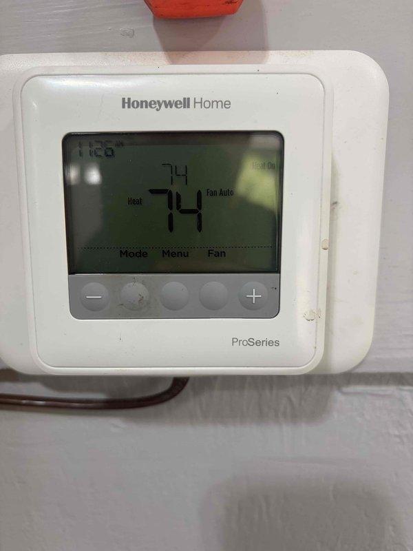 Responded to emergency no-heat call for garage furnace that would not shut off, causing space temperature to exceed 100 degrees. Upon arrival, gas supply had been shut off as safety precaution and thermostat batteries had been replaced. Inspected Honeywell ProSeries thermostat showing 74 degrees in heat mode with fan on auto setting. Examined furnace control board and gas valve assembly, checking all wire connections and electronic components for proper operation. Diagnosed thermostat malfunction causing continuous call for heat. Verified control board functionality and gas valve operation. Restored system to safe operating condition with proper temperature control.