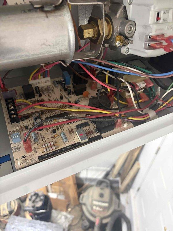 Responded to emergency no-heat call for garage furnace that would not shut off, causing space temperature to exceed 100 degrees. Upon arrival, gas supply had been shut off as safety precaution and thermostat batteries had been replaced. Inspected Honeywell ProSeries thermostat showing 74 degrees in heat mode with fan on auto setting. Examined furnace control board and gas valve assembly, checking all wire connections and electronic components for proper operation. Diagnosed thermostat malfunction causing continuous call for heat. Verified control board functionality and gas valve operation. Restored system to safe operating condition with proper temperature control.