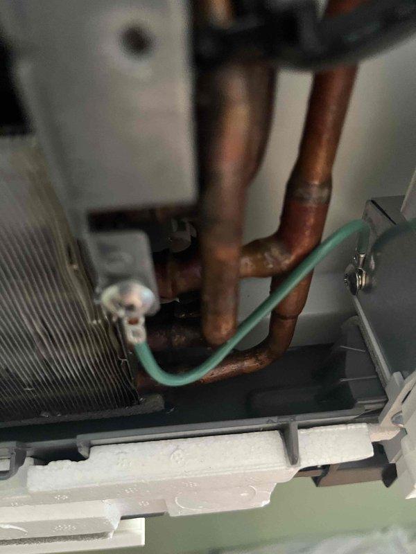 Responded to service call for mini split system with disconnected drainage tube. Reattached and secured drainage line to prevent future water leakage issues. Performed comprehensive heating maintenance inspection, checking refrigerant lines, internal components, and system operation. Verified system temperatures and confirmed unit operating within normal parameters at 67.9°F discharge temperature.