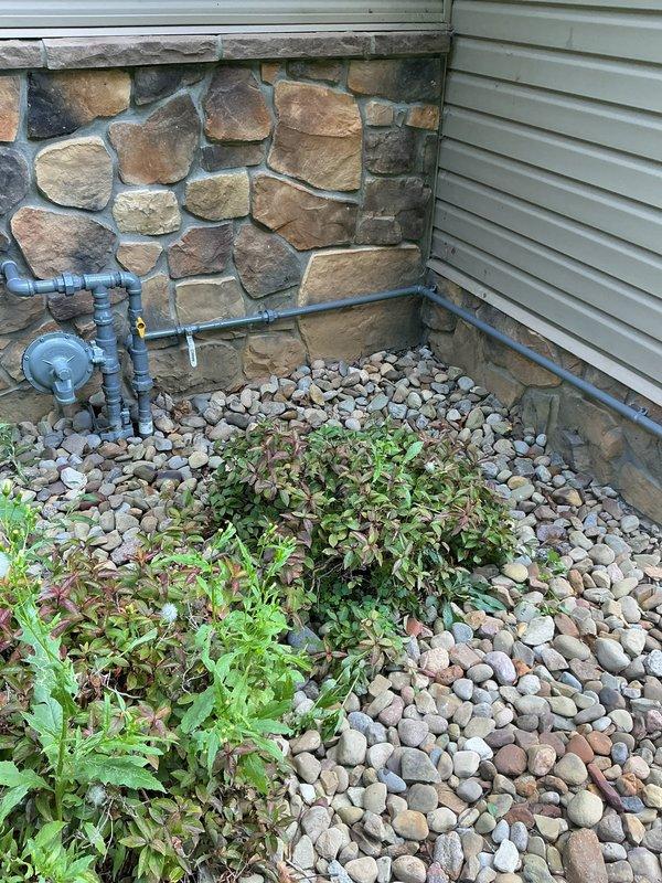 Completed gas line extension by teeing off the main supply line and running approximately 25-30 feet of pipe along the exterior wall to the HVAC unit. Installed new piping with appropriate fittings and connections to provide gas service to the equipment, ensuring proper support and code-compliant installation along the building's exterior.