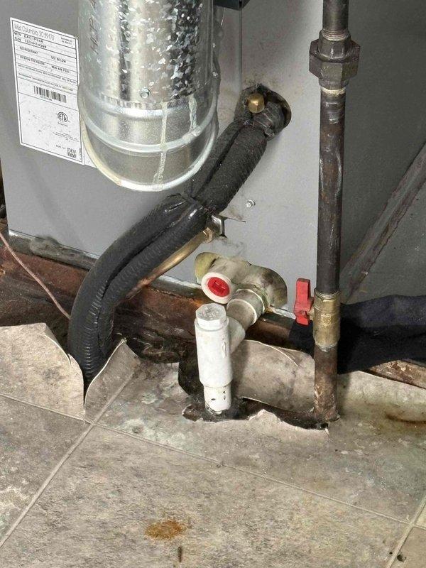 Responded to service call for HVAC system experiencing rattling sound followed by complete system failure. Upon arrival, inspected thermostat wiring and connections, documenting exposed terminal blocks and wire configuration. Evaluated full system including water heater and associated plumbing infrastructure in utility area. Provided estimate for complete system replacement due to age and condition of existing equipment.
