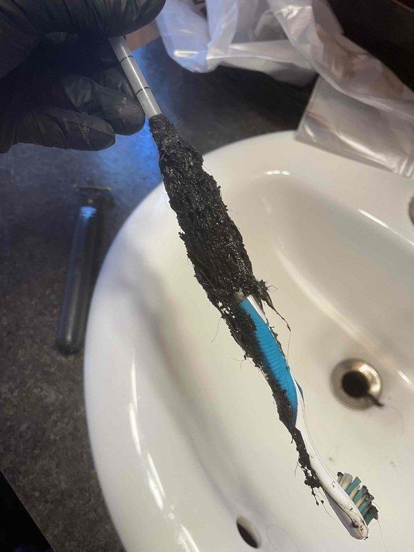 Responded to a sewage backup issue at cabin DC-4 where the toilet was backing up into the shower during peak occupancy. Successfully cleared the main drain line using mechanical augering equipment, removing significant accumulation of hair, soap residue, and organic debris from the system. Inspected exterior cleanout access point and verified proper drainage flow was restored to prevent future cross-contamination between fixtures.