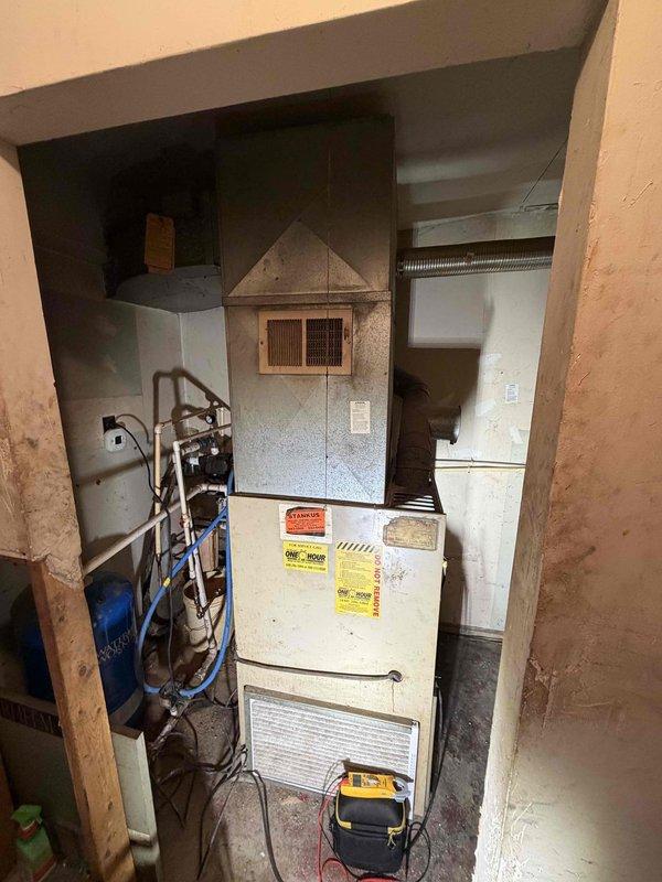 Responded to service call for furnace evaluation. Performed visual inspection of existing heating system located in utility space. Unit assessed for operational status and overall condition. Customer inquired about system replacement options and financing availability due to concerns about equipment age and performance. Documented current system configuration with heating-only setup, no cooling components present.