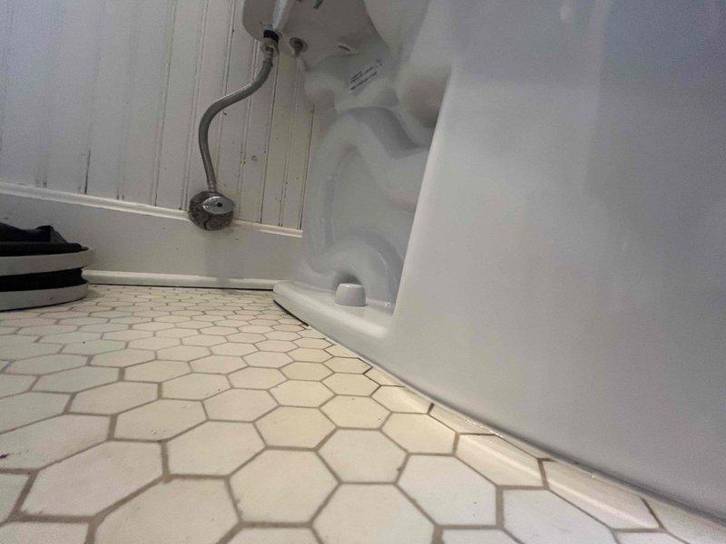 Responded to service call for deteriorating toilet mounting bolts. Upon inspection, found the closet bolts severely corroded and compromised due to prolonged water exposure, evidenced by extensive rust staining on the hexagonal tile flooring surrounding the toilet base. Removed and replaced the failed mounting hardware to restore proper toilet stability and prevent potential leaks or fixture failure. Addressed water damage indicators on floor surface around drain area.
