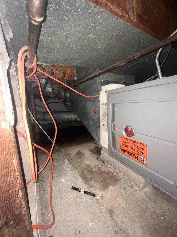 Responded to service call for furnace producing whistling sound. Upon inspection of HVAC system in attic space, evaluated furnace components, ductwork connections, and air handler configuration. Documented existing equipment condition including horizontal tank assembly, refrigerant lines, electrical disconnect, and duct installation with securing straps. Provided estimate for complete system replacement based on assessment findings.