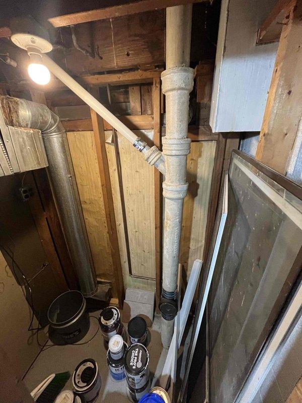 Responded to a recurring kitchen sink drainage issue that developed approximately 2-3 weeks following previous service visit in July. Upon arrival, inspected under-sink plumbing configuration including drain assembly, P-trap, and associated PVC drainage piping. Observed evidence of previous water collection in cabinet space. Conducted visual inspection of basement plumbing infrastructure, examining vertical drainage stack, venting system including previously installed Air Admittance Valve (AAV), and horizontal drain lines. Documented plumbing configuration with photographs showing drain connections, waste lines, and venting components. Customer expressed concerns regarding drainage performance since AAV installation and questioned code compliance of current configuration. Completed diagnostic assessment of drainage system and prepared findings for technical review prior to presenting repair options.