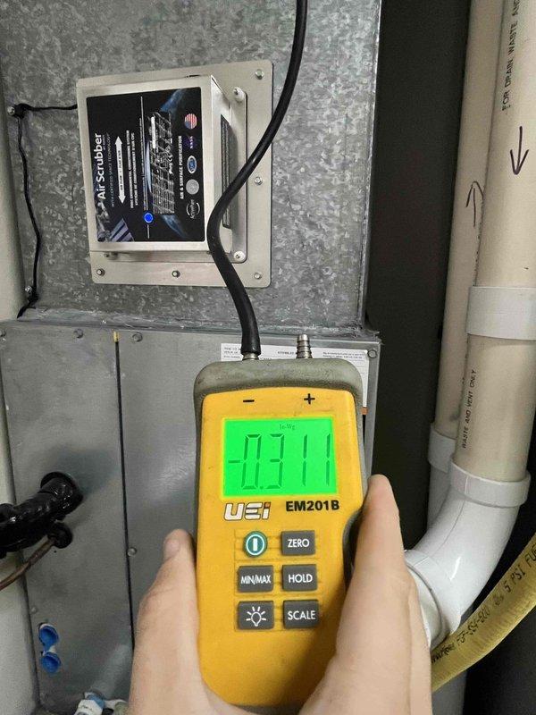 Completed heating system maintenance and renewal inspection on air handler unit. Identified and documented major air restriction issue causing system overheating condition, as indicated by warning tag on valve assembly. Verified static pressure readings using digital manometer, which measured 0.31 inches water column at ductwork. Inspected mounted control module and electrical connections on supply plenum to ensure proper operation and safety compliance.