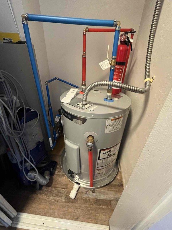 Performed complete tank flush on residential water heater due to customer complaint of foul-smelling water. Upon inspection, discovered significant sediment accumulation at bottom of tank. Drained unit completely and flushed system multiple times until water ran clear. Removed and displayed sediment filter showing substantial dark granular debris that had collected in the system, confirming the source of the odor issue. Verified all connections, including PEX manifold system and relief valve, remained secure throughout the procedure. Refilled tank, checked for proper operation, and confirmed water quality improvement. System restored to normal function with odor issue resolved.