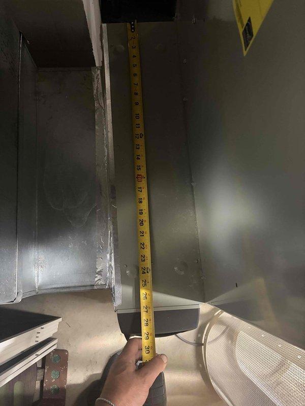 Responded to no cooling complaint on 8-year-old R41OA mini split system. Found indoor unit powered on with indicator light functioning but fan motor not operating. Performed diagnostic measurements of interior components and documented clearances within the air handler assembly. System requires fan motor replacement or further electrical troubleshooting to restore cooling operation.