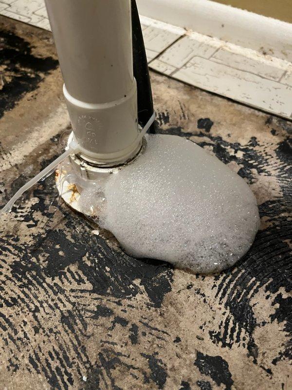 Responded to callback for possible leak at utility sink pipe following recent service. Upon inspection, discovered insufficient silicone sealant application around faucet base allowing water infiltration. Removed existing inadequate sealant, thoroughly cleaned and dried mounting surface, and properly resealed faucet base with appropriate silicone application to prevent future leakage. Verified no active leaks present and confirmed proper seal integrity.