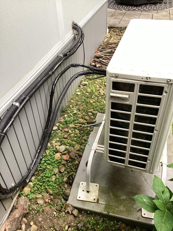 Completed estimate for replacement of 8-year-old mini-split system that had ceased cooling operation. The outdoor condensing unit showed signs of age and weathering, with visible rust staining around refrigerant line connections and discoloration on exterior surfaces. Indoor unit displayed power to the control panel but fan motor was inoperative, indicating potential compressor or control board failure requiring full system replacement evaluation.
