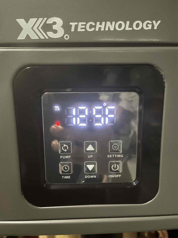 Responded to callback for non-functional tankless water heater with unresponsive power button. Upon arrival, performed diagnostic testing using digital moisture/humidity meter in attic space where unit is installed, recording reading of 72% which indicated elevated humidity levels near equipment. Inspected X3 Technology control panel and found display showing error code 18:88. Tested all control panel functions including pump, temperature adjustment, settings, timer, and power button. Determined control board was experiencing power delivery issues likely related to environmental moisture exposure in attic installation location. Documented equipment conditions and diagnostic readings with photos for warranty and follow-up purposes. Contacted dispatch to coordinate next steps for control board replacement or further electrical diagnostics.
