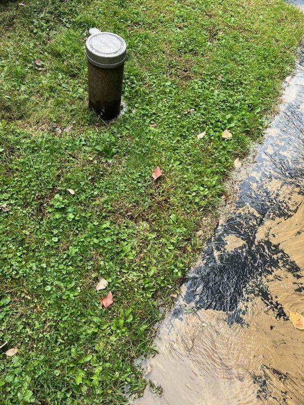 Responded to no water service call and investigated pitless adapter with water puddling in basement area. Upon inspection, found significant water accumulation around pitless adapter unit with visible pooling on ground surface and driveway. Documented conditions showing water discharge from pitless adapter creating muddy, saturated conditions around well access point, indicating potential seal failure or adapter malfunction requiring further diagnostic evaluation.
