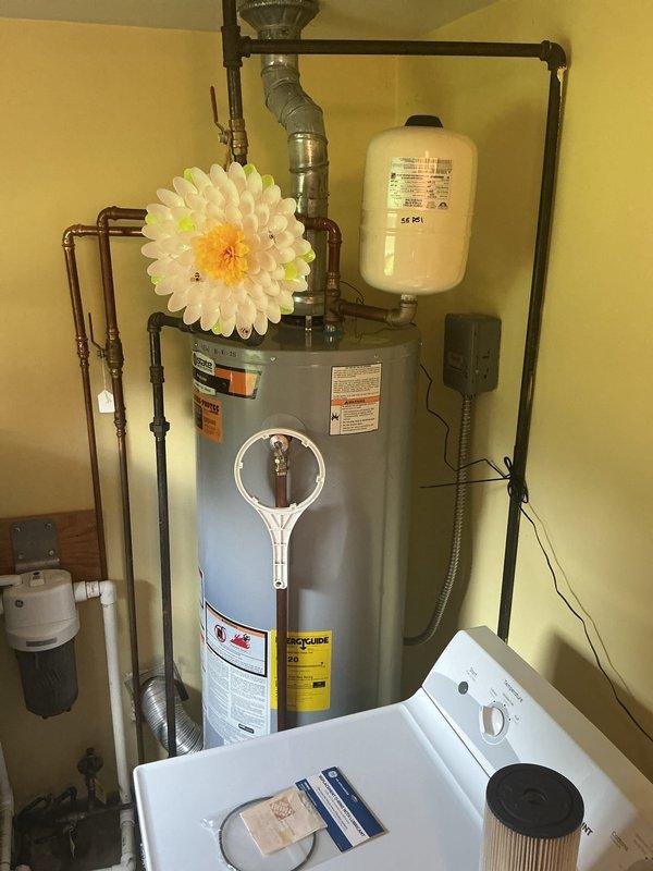 Completed plumbing membership visit and comprehensive system inspection. Evaluated traditional tank-style water heater in utility room, noting all connections, expansion tank, and associated copper piping in satisfactory condition. Identified outdoor water spigot requiring replacement due to wear and addressed critical inquiry regarding tankless water heater conversion feasibility for future consideration.