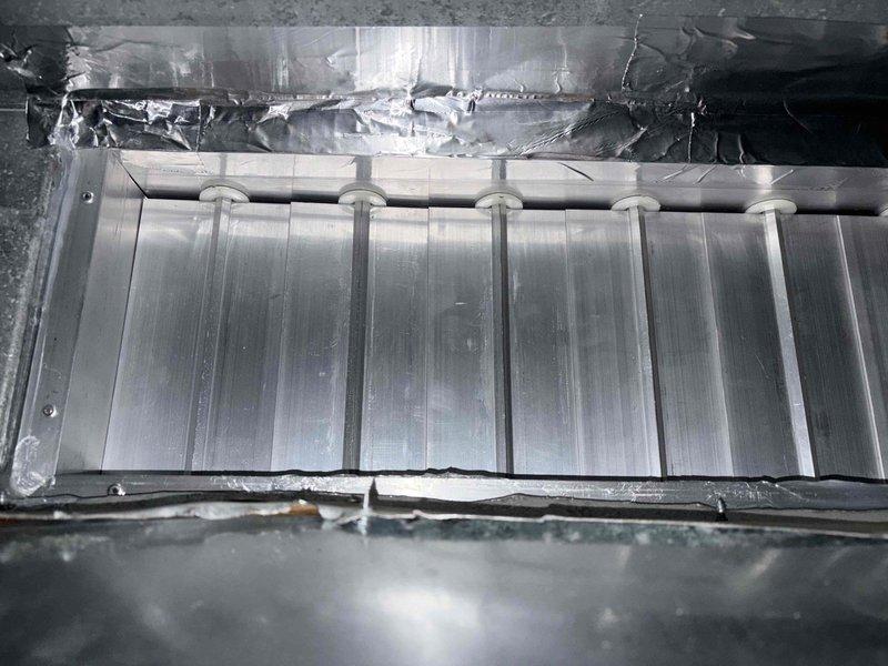 Responded to callback for newly installed HVAC system continuously running despite recent service. Used anemometer and manometer to verify zero airflow at registers in affected zone, confirming damper or zoning control failure. Inspected Honeywell zone control module and damper actuator connections, documented system configuration and damaged insulation near evaporator coil for further corrective action.