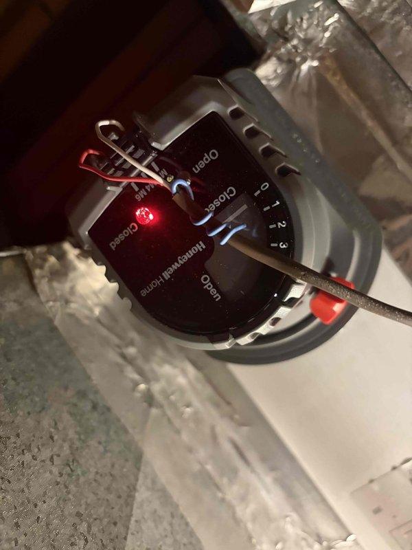 Responded to callback for newly installed HVAC system continuously running despite recent service. Used anemometer and manometer to verify zero airflow at registers in affected zone, confirming damper or zoning control failure. Inspected Honeywell zone control module and damper actuator connections, documented system configuration and damaged insulation near evaporator coil for further corrective action.