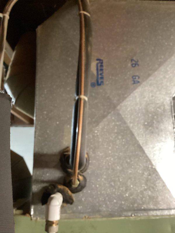 Performed comprehensive AC tune-up on 40-year-old air conditioning system currently operating without issues. Conducted standard maintenance inspection and servicing procedures, documenting equipment condition through interior component photography showing copper refrigerant lines, mounting hardware, and cabinet structure. System found to be functioning properly with no reported symptoms or accessibility concerns at time of service.