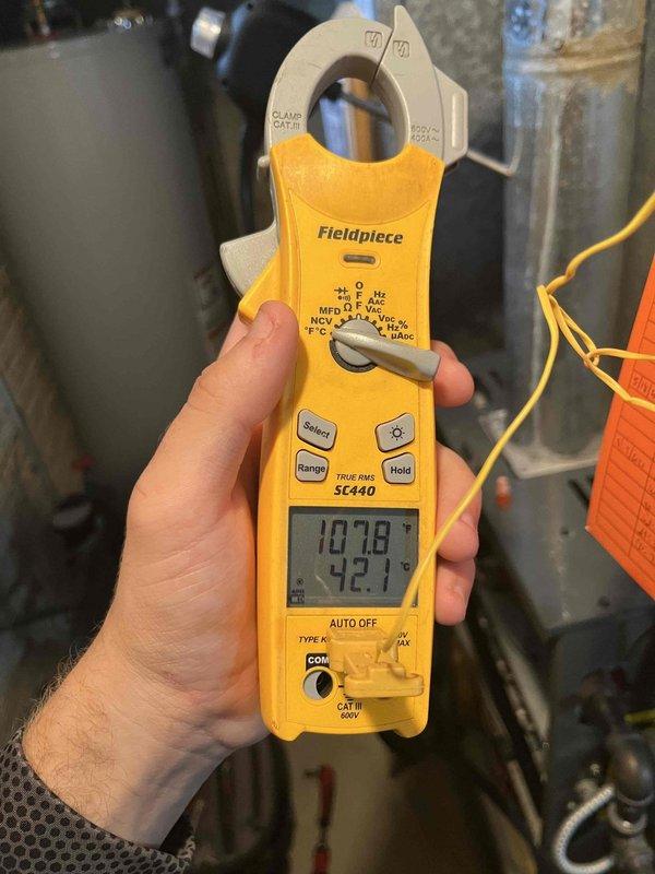 Completed heating maintenance member club visit on air handler system. Performed standard diagnostics using clamp meter, recording temperature readings of 707.8°F and 72.7°F at various system points. Inspected and serviced condensate drain system components, including float switch assembly with metal probe sensor.