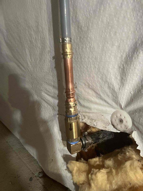 Completed water treatment system inspection and documented operational status of water softener unit. Verified combustion chamber flame pattern and burner assembly operation, confirming proper blue flame with minimal orange tipping indicating efficient gas combustion. Inspected plumbing connections, compression fittings, and valve assemblies associated with water treatment system installation. Scheduled follow-up inspection in one month to drain water softener, verify proper system operation, and conduct iron level testing to determine if additional water treatment measures are required.